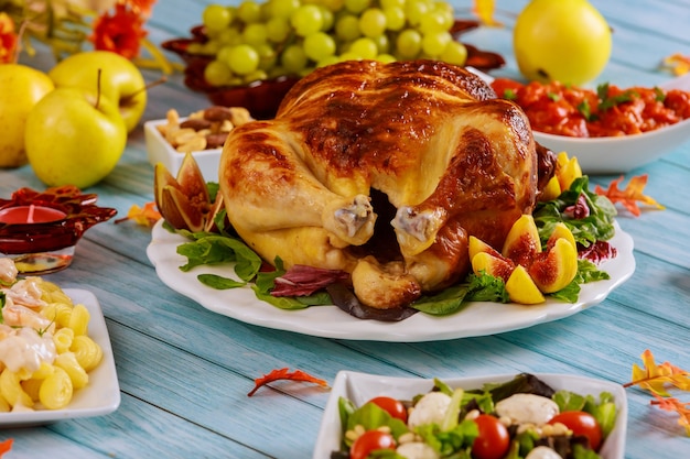 Crispy roasted chicken with salad on festive Thanksgiving Day table.