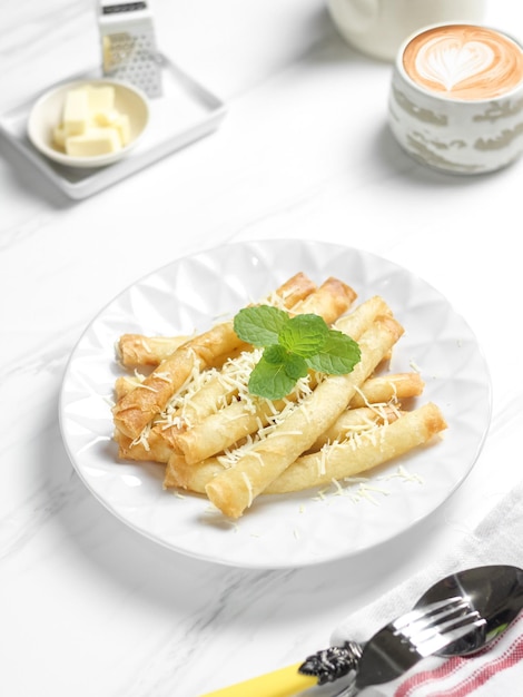 Crispy roll cheese in white plate. Crispy roll cheese is cheese that is cut and rolled with pastry s