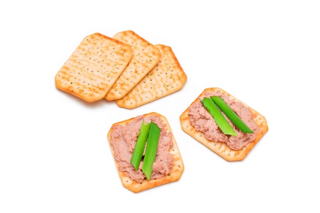 Crispy salted cracker with liver pate and green onions  isolated