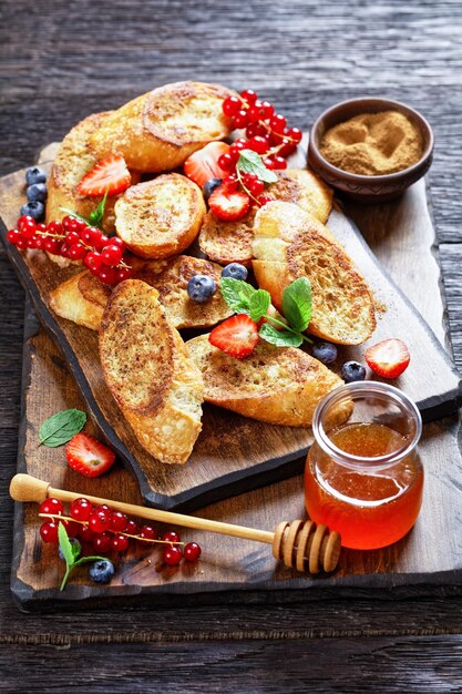 Crispy sweet toasts with fresh berries and honey