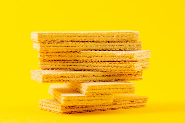 Crispy waffle sticks on a yellow background