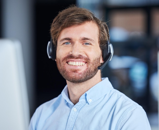 CRM happy customer service or consultant man with smile in office for success telemarketing or communication Sales advisor call center or portrait for contact us consulting or customer support