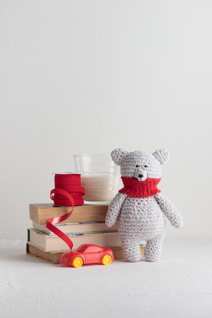 Photo crochet knitting cute teddy bear with books and a toy