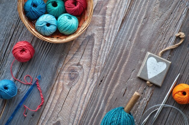 Crochet, top view on yarn balls on rustic wood