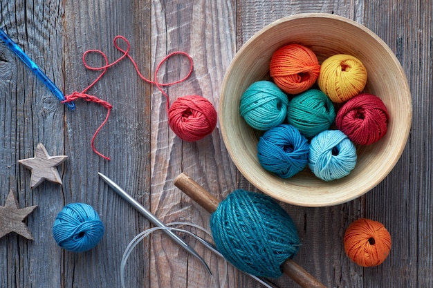 Crochet, top view on yarn balls on rustic wood