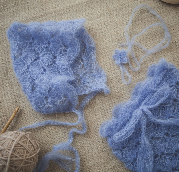 Crochet warm blue clothes for a baby