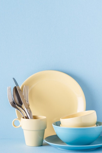 Crockery and cutlery on a blue pastel