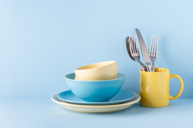 Crockery and cutlery on a blue pastel