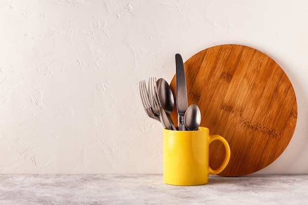 Crockery and cutlery on a light table with copy space