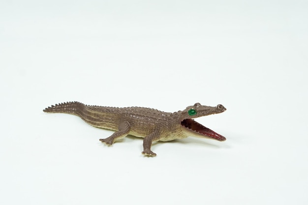 Crocodile mini figure isolated on white background. Plastic animal toys.