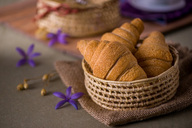 Croissant bun in basket on the breakfast table