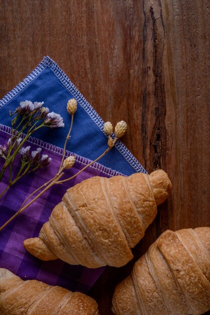 Croissant buns on the wooden table.