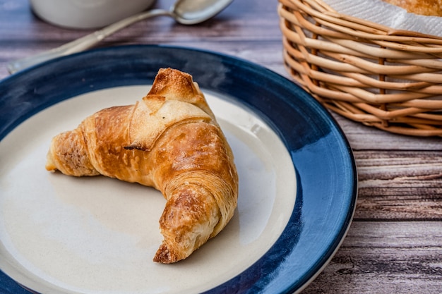 Croissant or medialuna on a small plate.