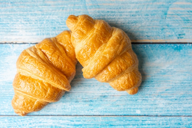 Croissant pile on wooden background