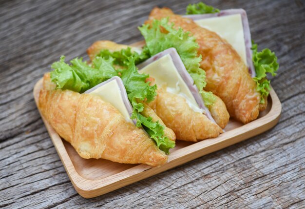 Croissant salad ham vegetable - croissant sandwiches on wooden table