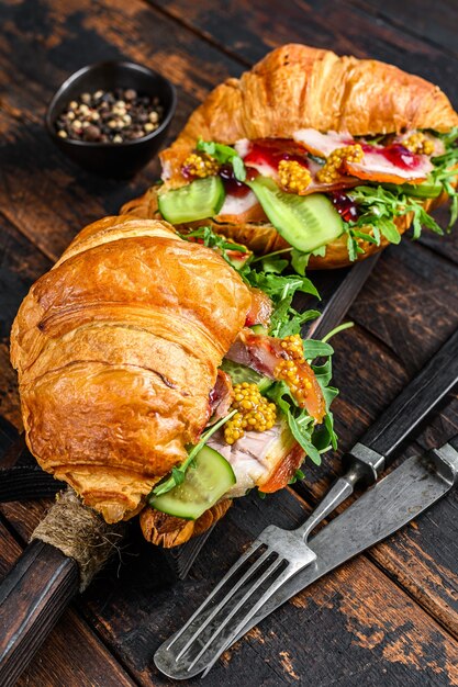 Croissant sandwich with cheese, arugula, and ham