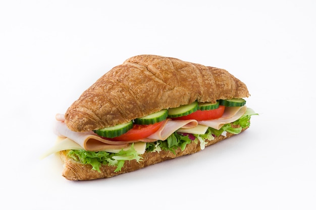 Croissant sandwich with cheese, ham and vegetables isolated on white