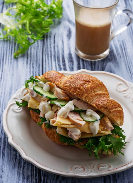 Croissant sandwich with chicken, cheese, cucumber