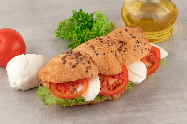 Croissant sandwich with lettuce mozzarella and tomato