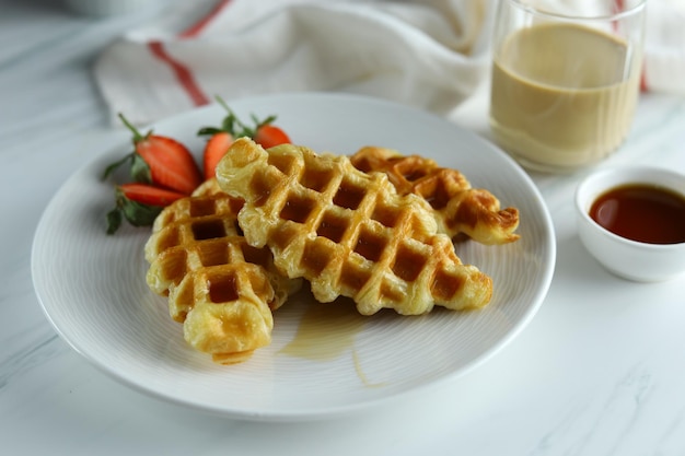 Croissant Waffle or croffle in white plate with strawberry