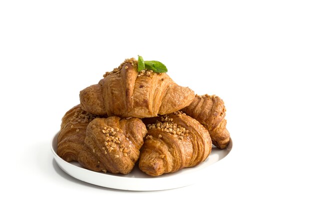 Croissant with almonds on white background