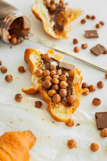 Photo croissant with chocolate paste and nuts