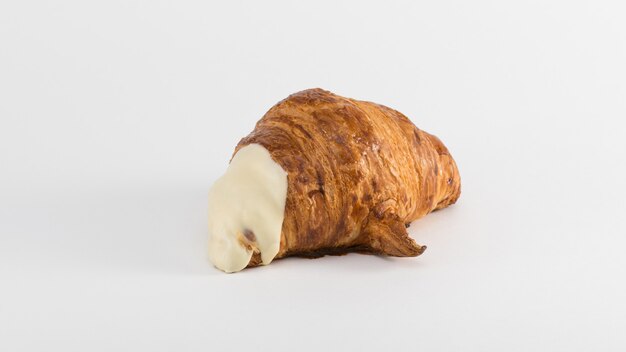 Croissant with cream filling on a white background