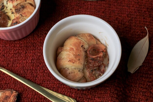 Croissant with ham cheese in mini cup on red background selective focus morning breakfast concept healthy and fast food