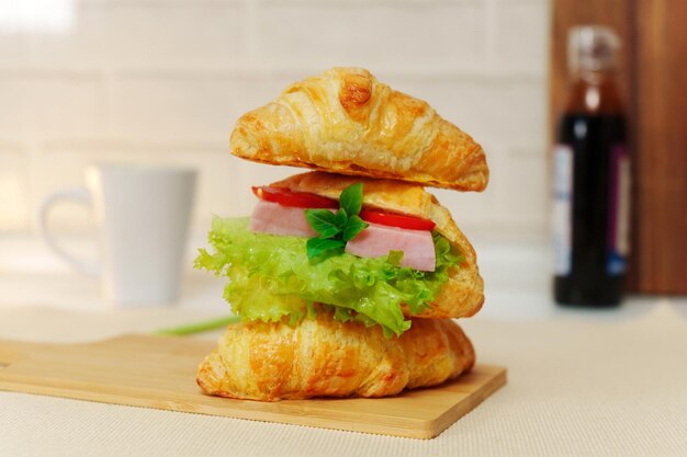 Croissant with ham ricotta mint and salad closeup delicious breakfast