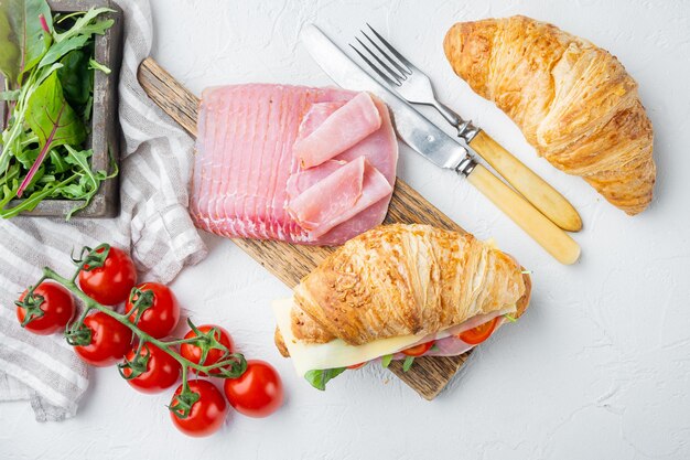 Croissant with ham set, with herbs and ingredients, on white stone  background, top view flat lay