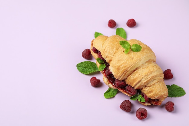 Croissant with raspberry jam on purple Ã¢ÂÂbackground