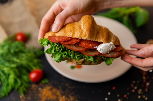 Croissant with salami and tomatoes