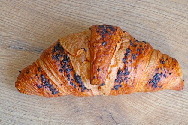 Croissant on a wooden background Fresh and tasty pastries Croissant for coffee or tea for breakfast