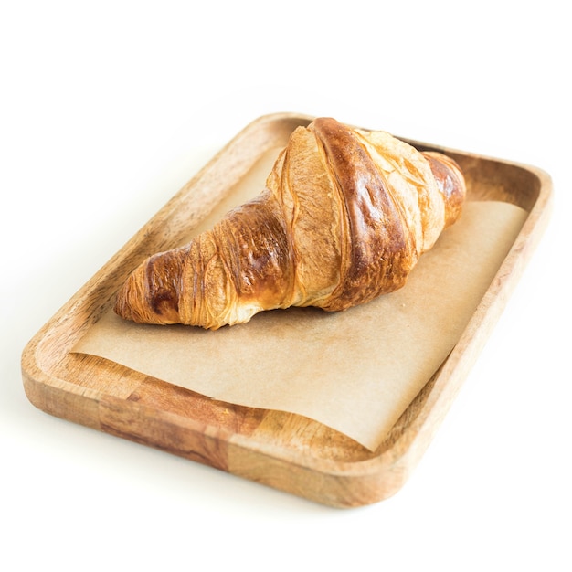 Croissant on a wooden server isolated