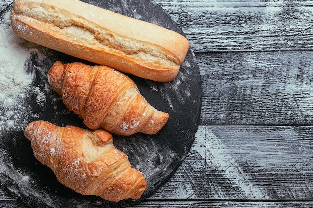 Croissants, baguette. Croissants are fresh on a white wooden background. French cuisine