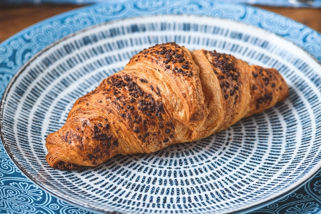 Croissants on a blue plate close up.