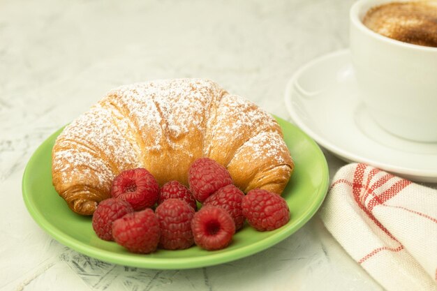 Croissants and fresh raspberries Fresh and delicious croissants