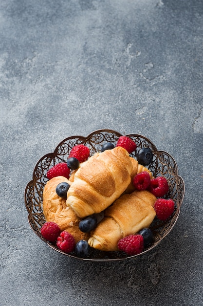 Croissants met verse frambozen en bosbessen