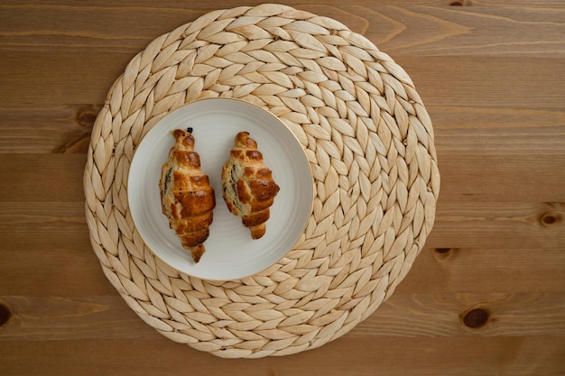 Croissants on a plate on a wooden background top view