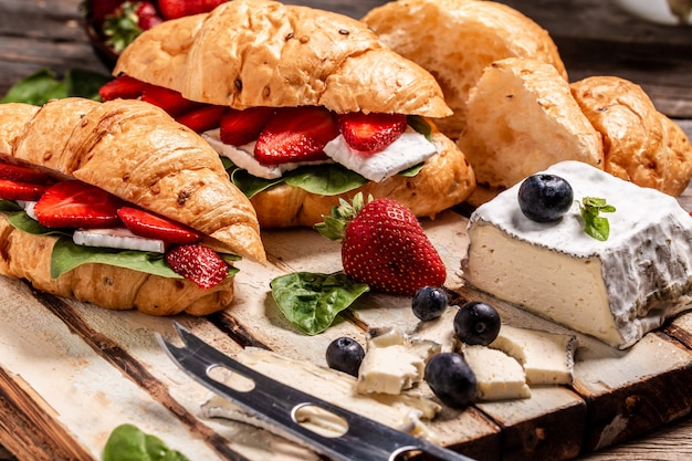 Croissants with soft cheese and fresh strawberries.