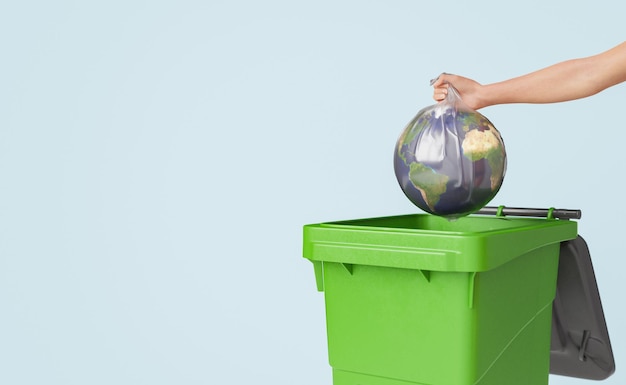 Crop anonymous woman throwing globe into trash can