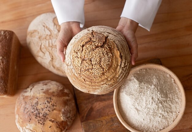 Crop baker showing loaf of bread