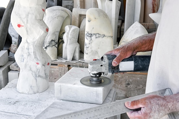 Crop craftsman polishing marble in workshop