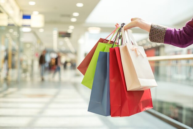 Crop hand holding shopping bags