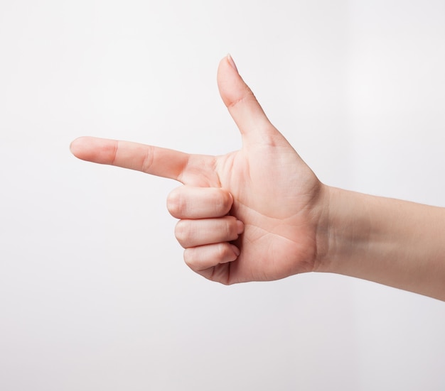 Crop hand showing hand gun gesture