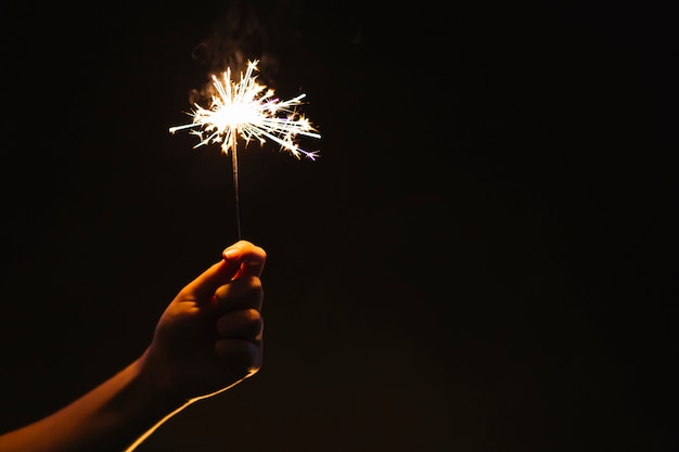 Crop hand with sparkler