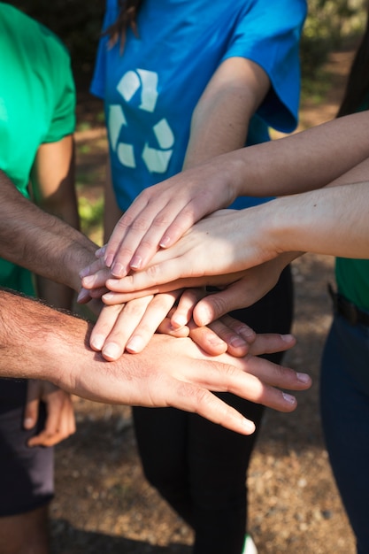 Crop hands of activists on each other