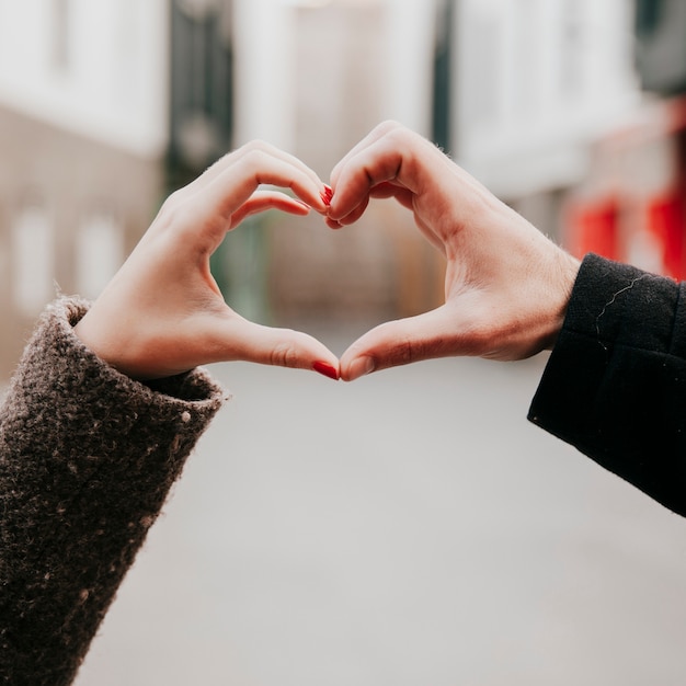 Crop hands making heart gesture