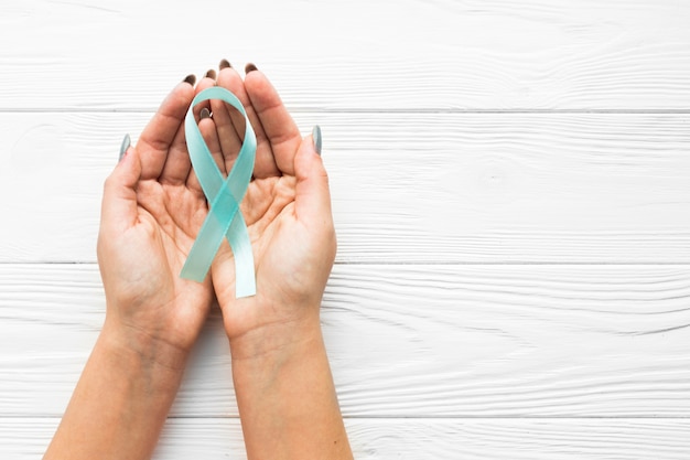 Photo crop hands with prostate cancer ribbon