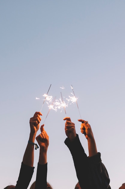 Crop hands with sparklers